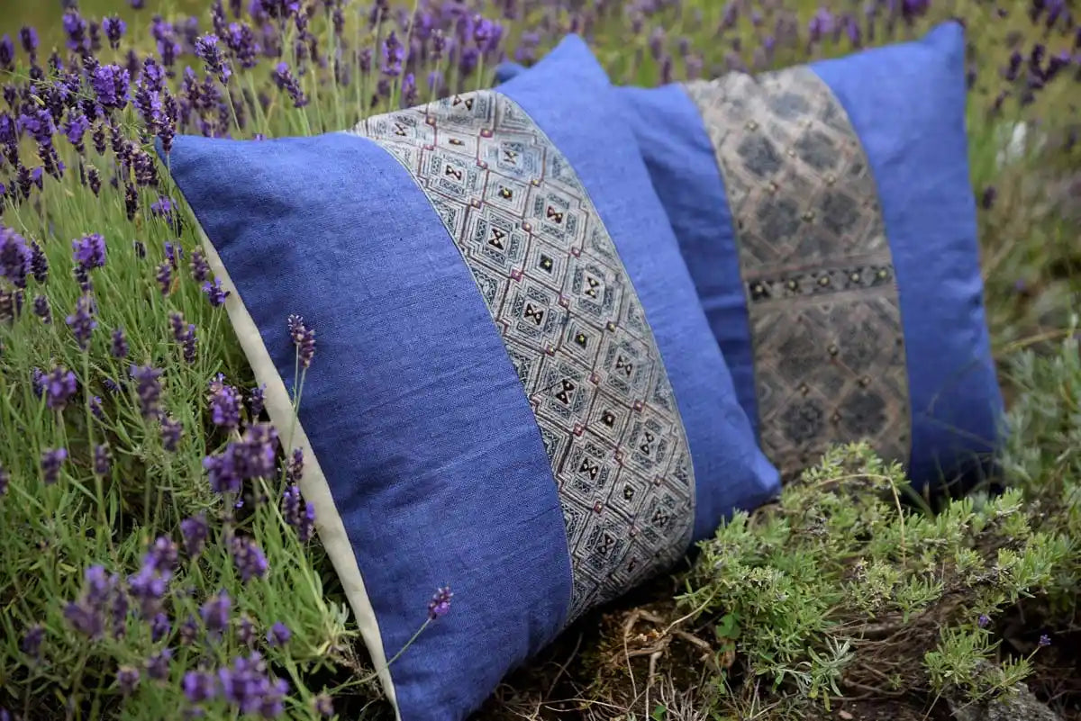 Blue H’mong cushions lined up in natural setting