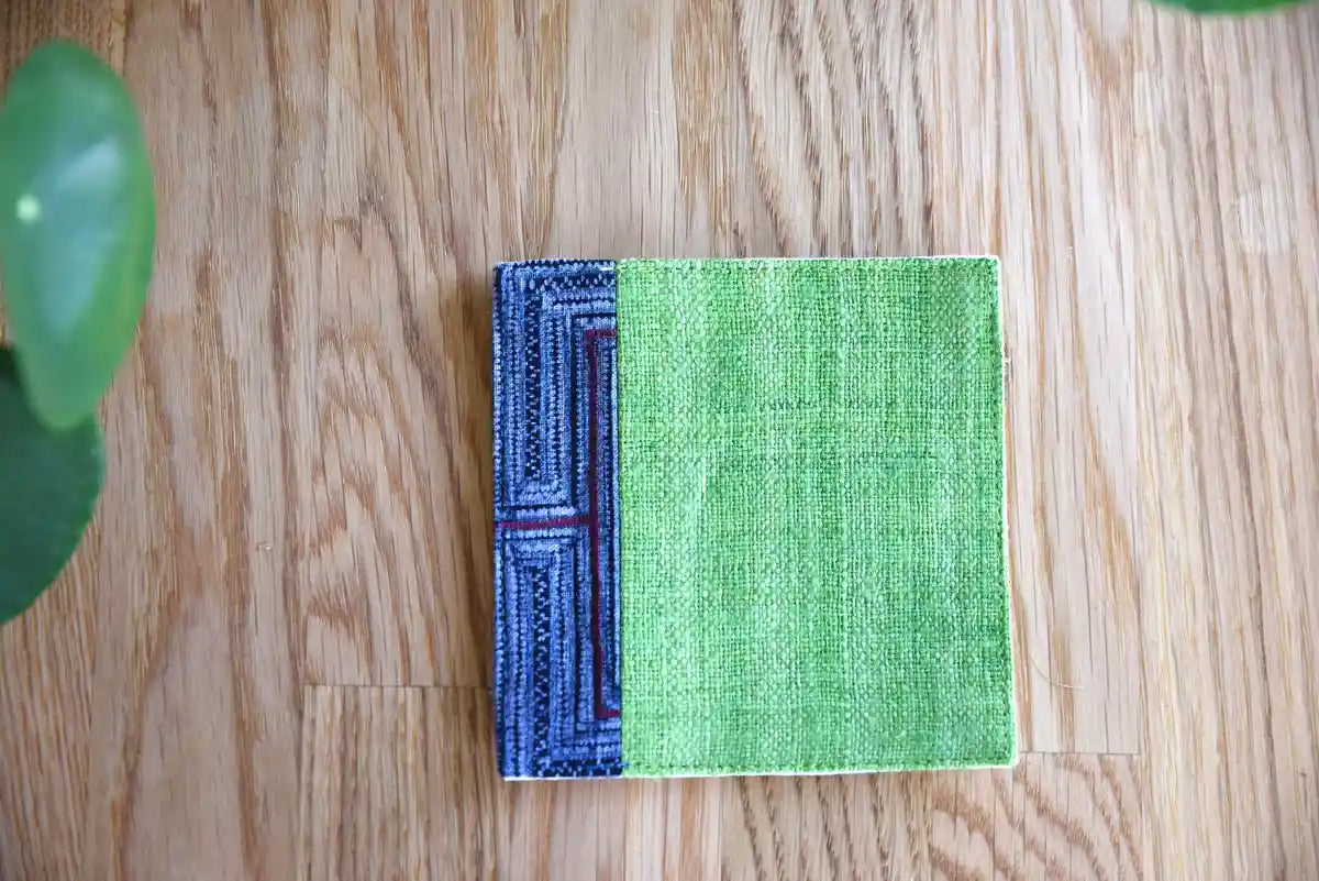 Variant pattern of indigo trim on green hemp coaster