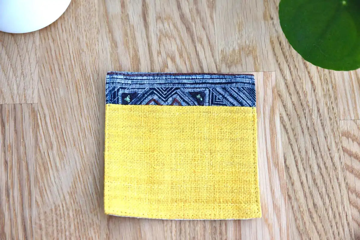 Variant pattern of indigo trim on yellow hemp coaster