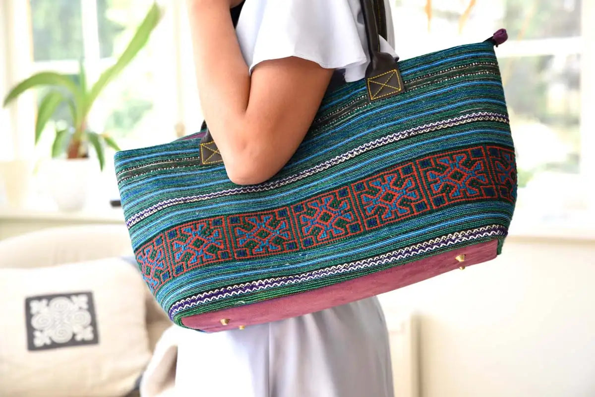 Woman carrying Vindigo hemp tribal tote with pink interior