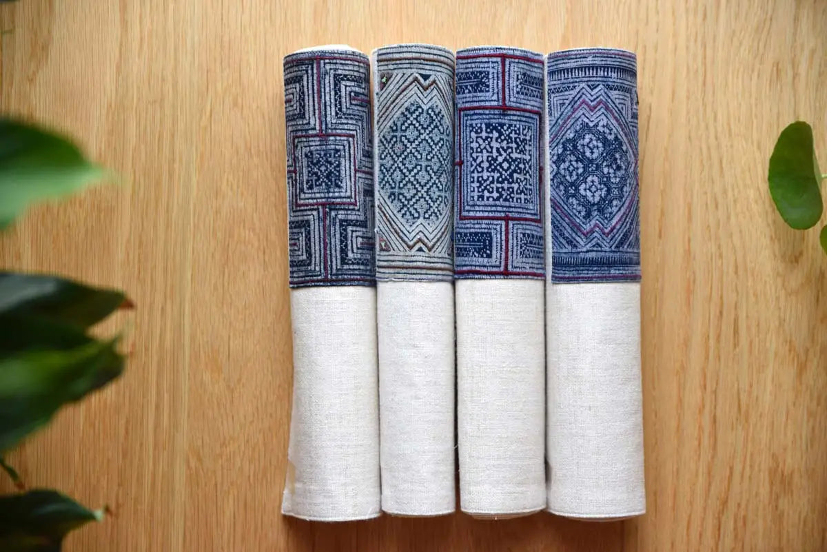 Rolled cream hemp napkins with blue indigo woven detail