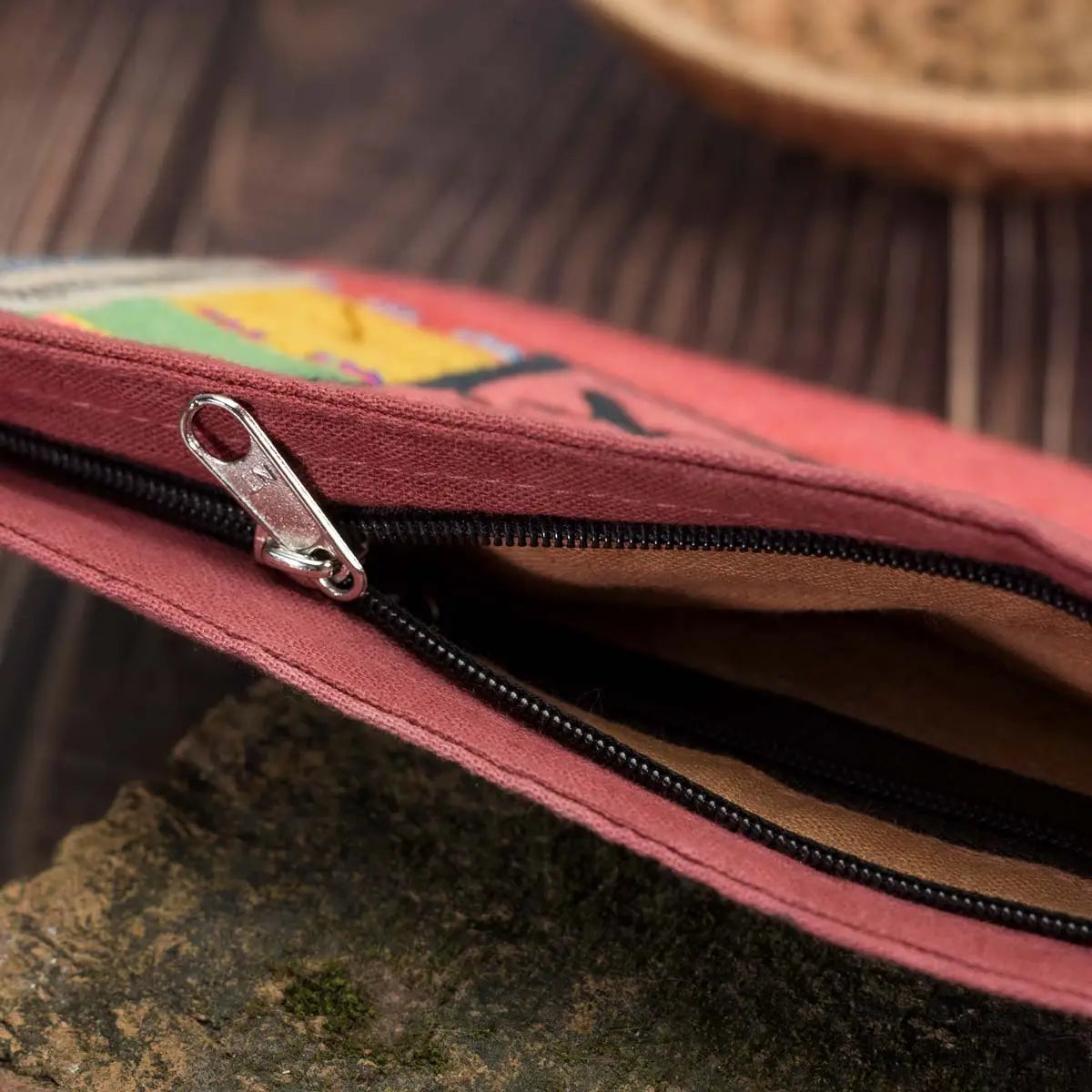 Vindigo hemp cosmetic bag zipper close-up showing red trim and embroidery