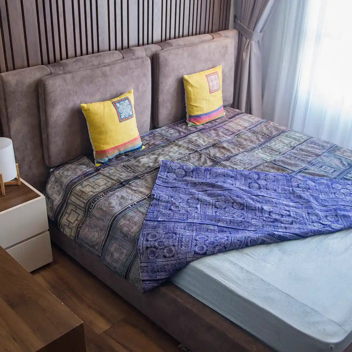 Vindigo purple cotton bed cover corner view showing dual-sided batik and embroidery