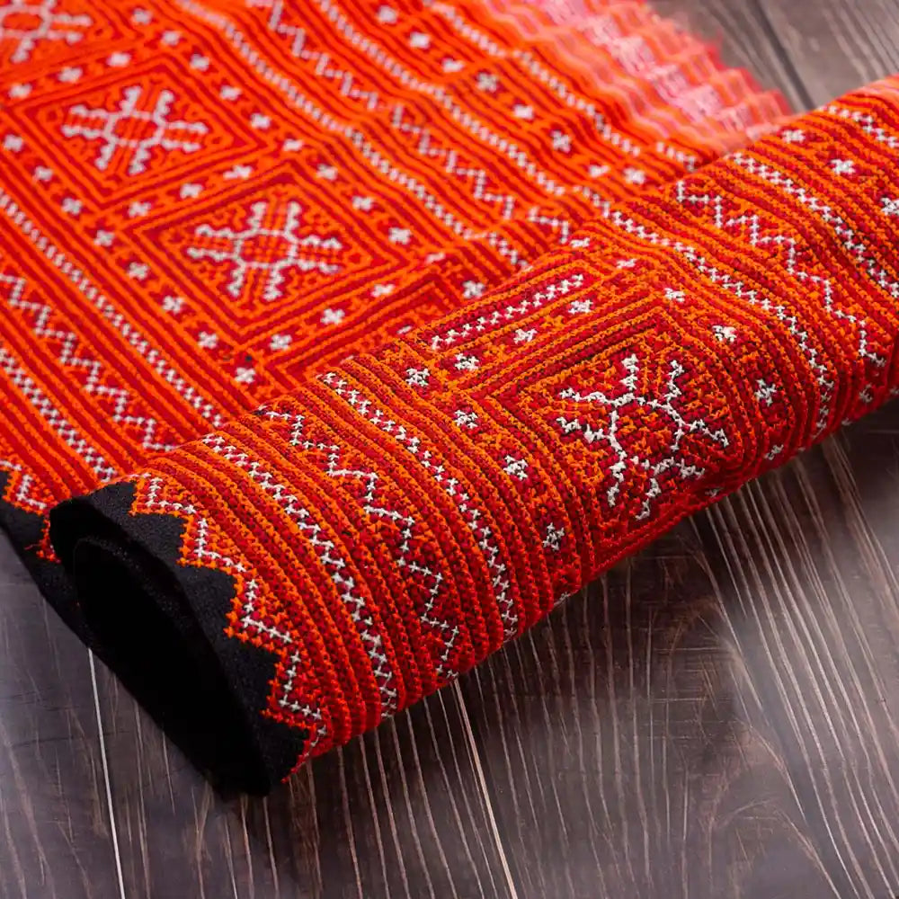 Vindigo red hemp embroidered tribal fabric folded detail close-up