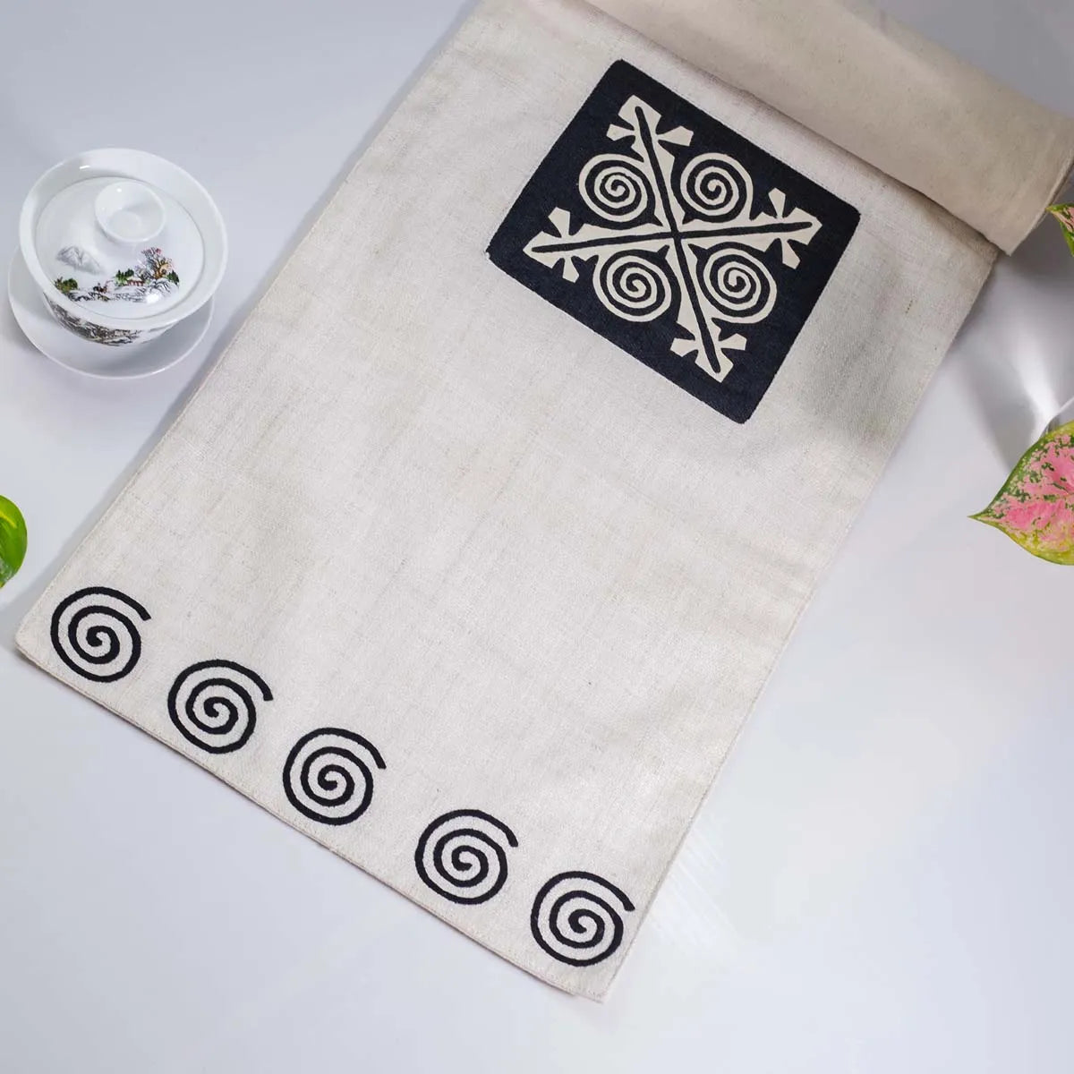 Vindigo beige hemp table runner full layout showing black spiral ends and central motif