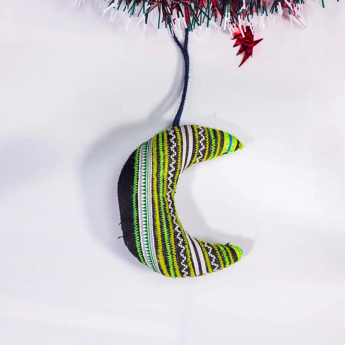 Vindigo green tribal embroidered crescent moon ornament hanging close-up