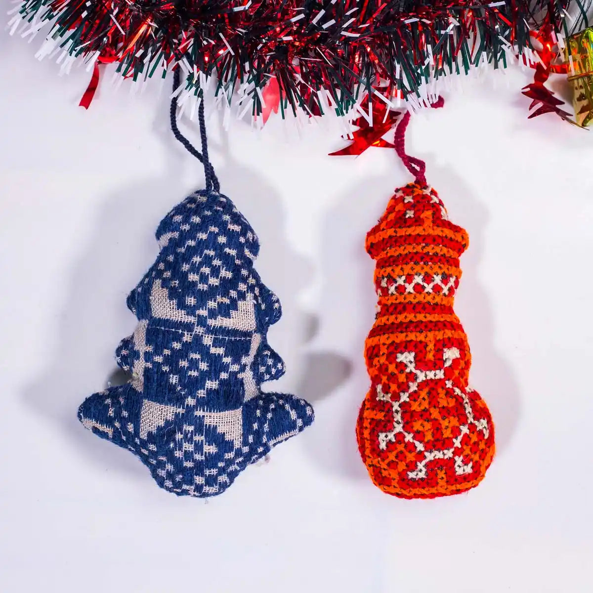 Vindigo handmade blue and red tribal embroidered ornaments hanging under garland
