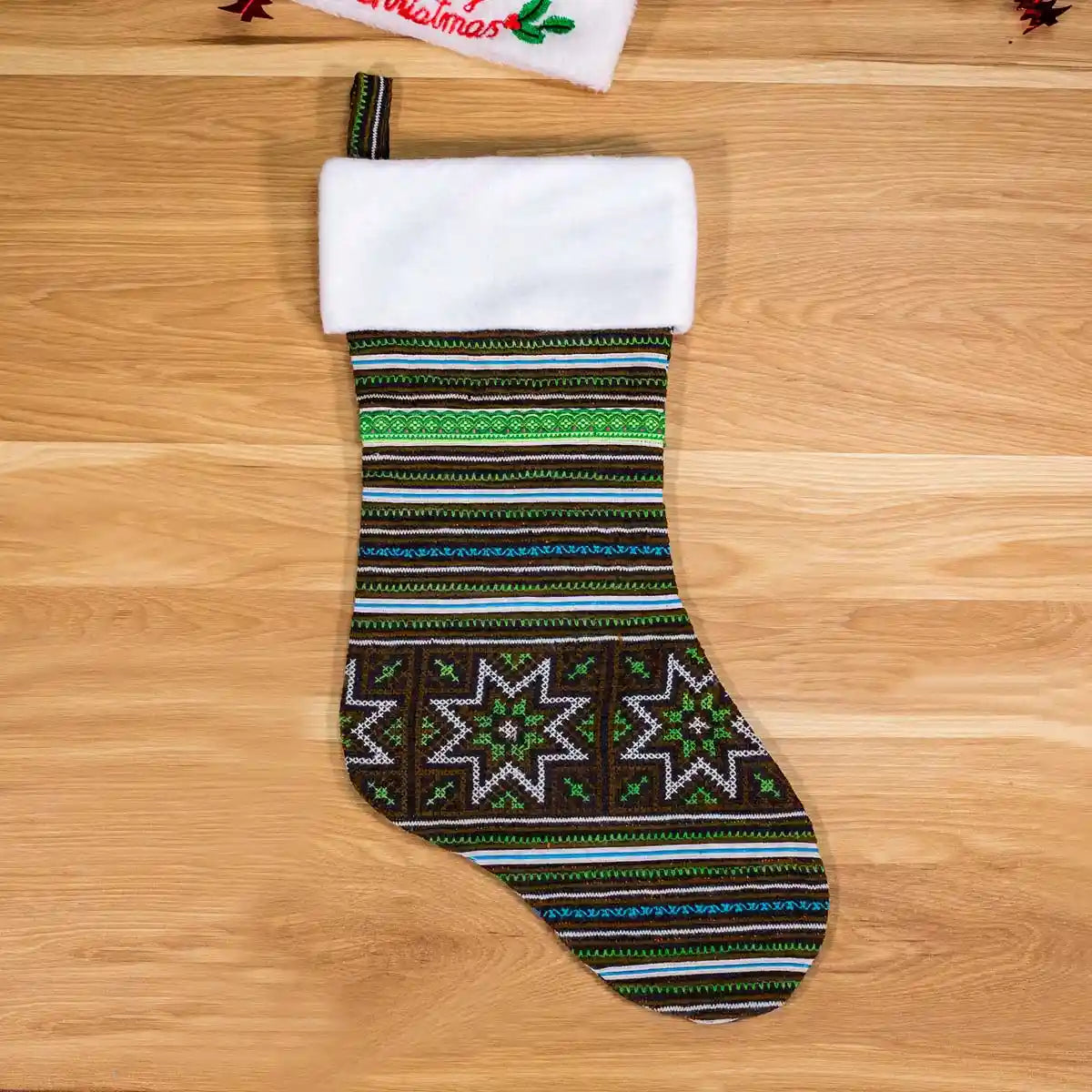 Vindigo green and black geometric embroidered Christmas stocking wooden background