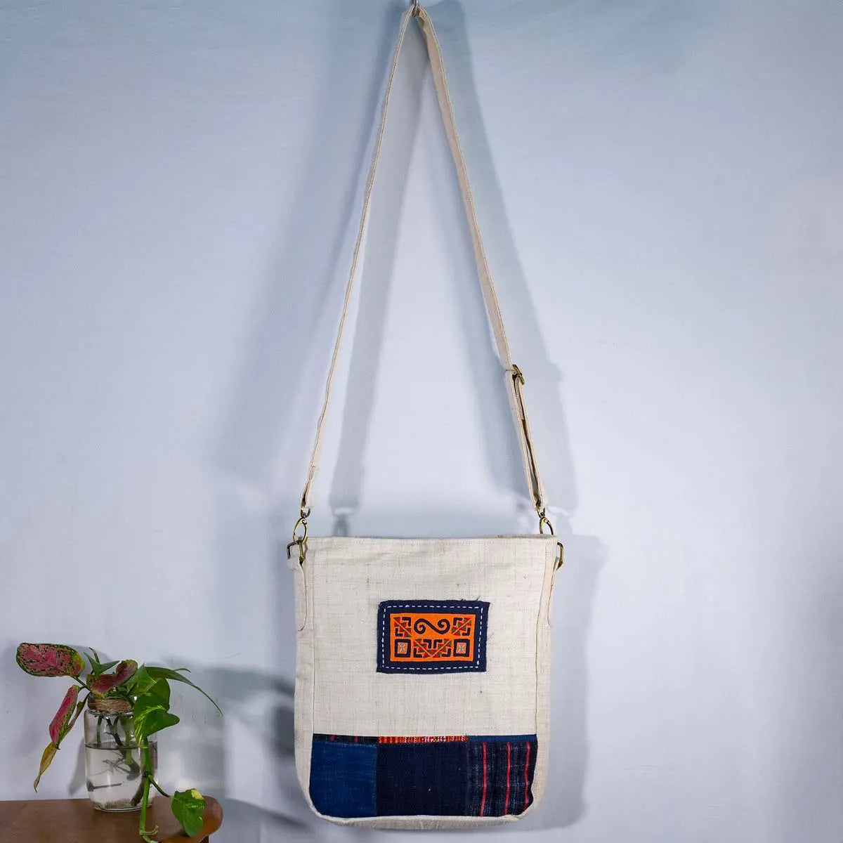 Vindigo natural hemp crossbody bag hanging display with tribal patch