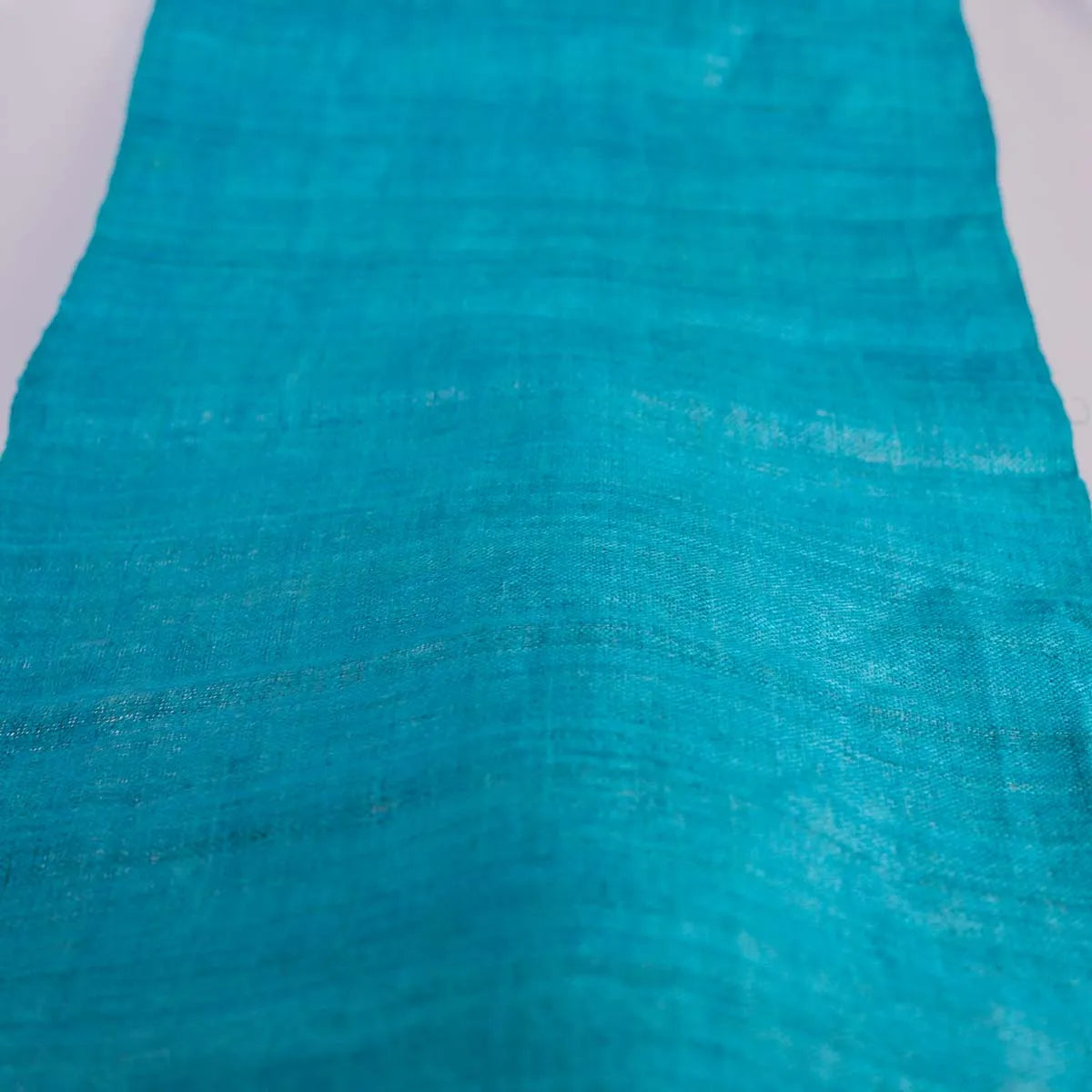 Vindigo turquoise hemp fabric laid flat on white surface