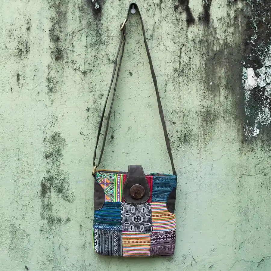 Vindigo multicolor H’mong patchwork crossbody bag hanging front view on wall