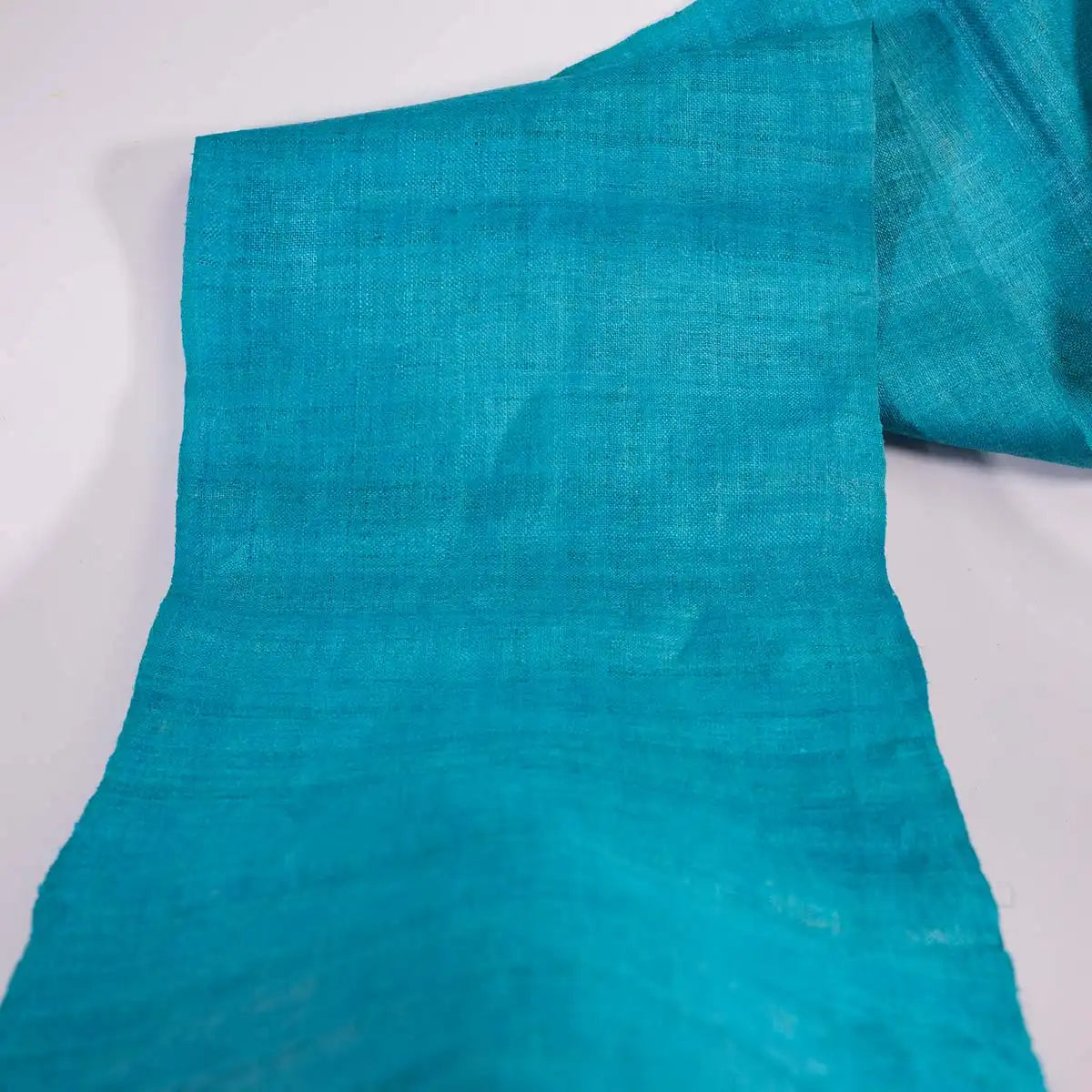 Vindigo turquoise plain hemp fabric roll opened partially
