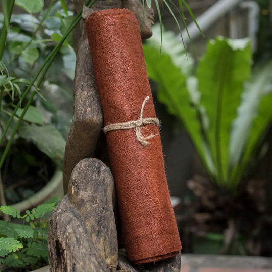 Vindigo orange hemp fabric roll styled in outdoor natural scene