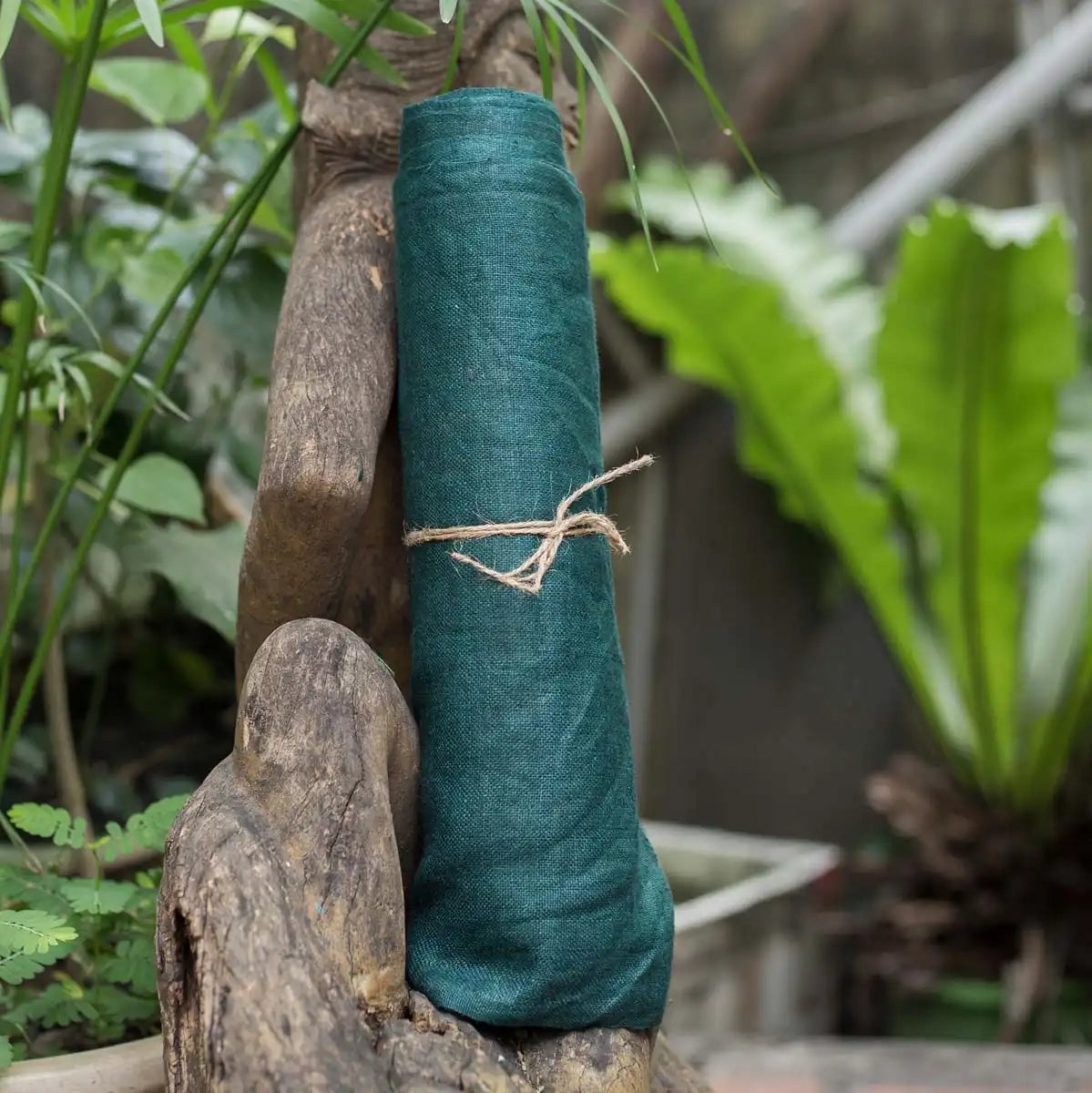 Vindigo green hemp fabric roll styled naturally outdoors
