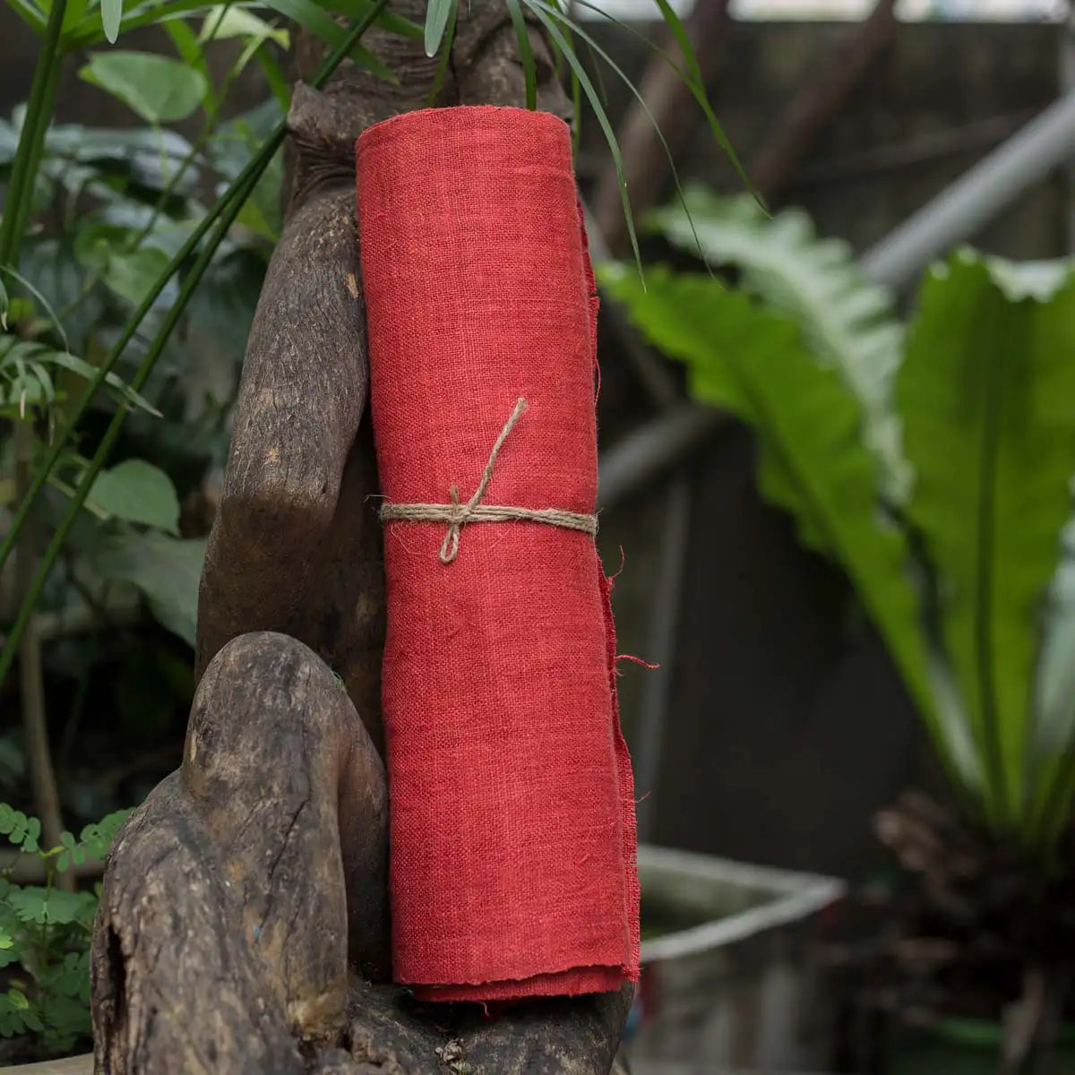 Vindigo red hemp fabric roll styled naturally outdoors