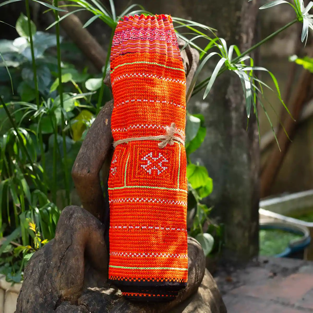 Vindigo red hemp tribal embroidered fabric roll displayed outdoors