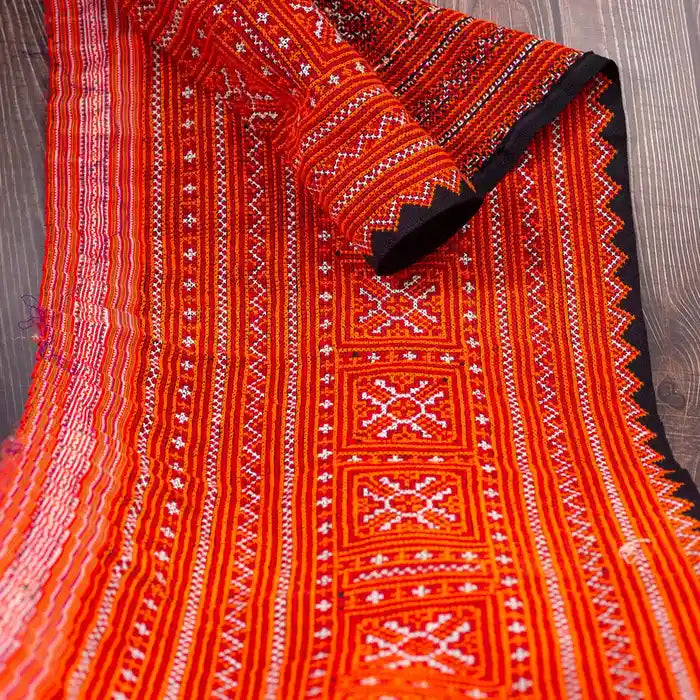 Vindigo red hemp embroidered fabric roll close-up detail