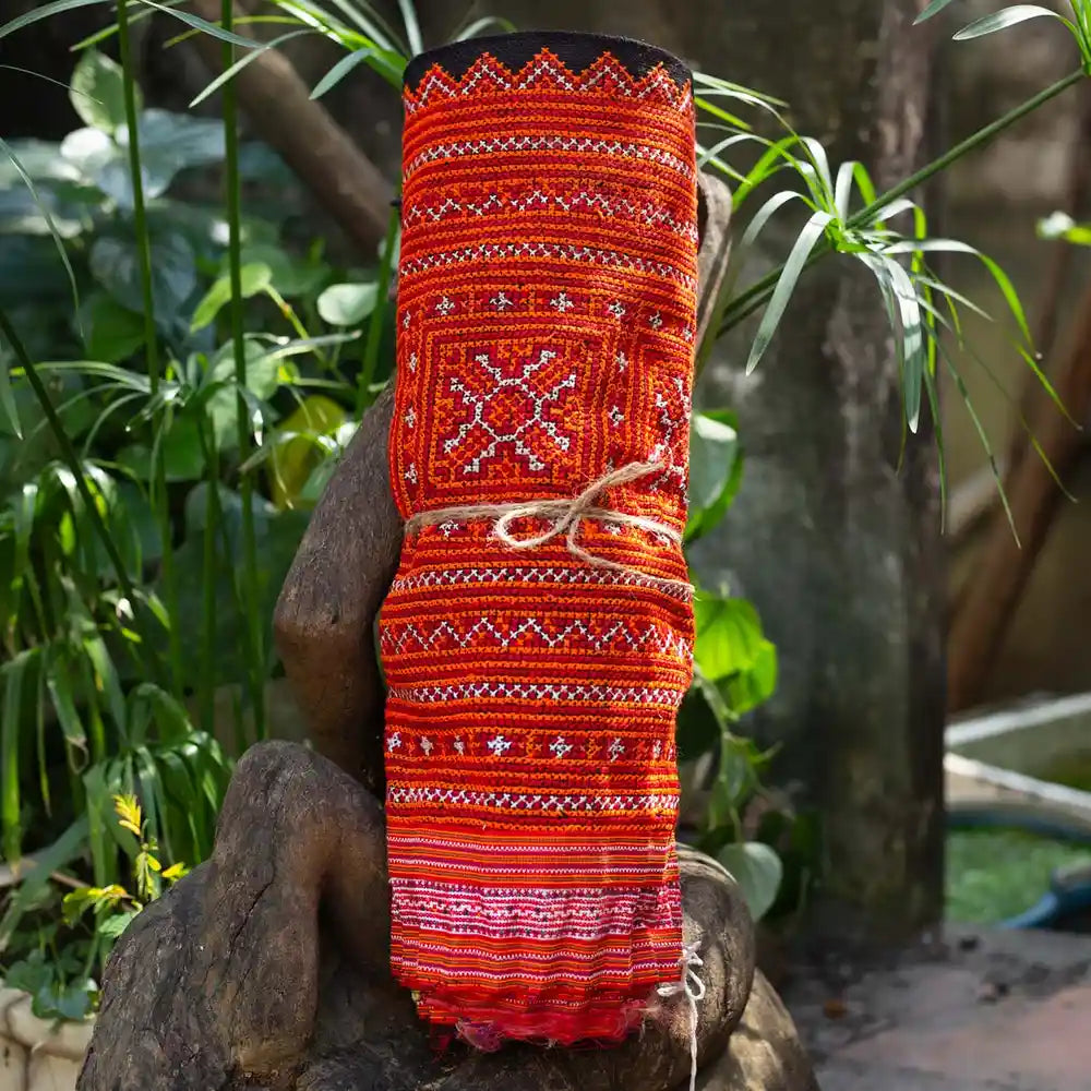 Vindigo red hemp embroidered fabric roll close-up detail