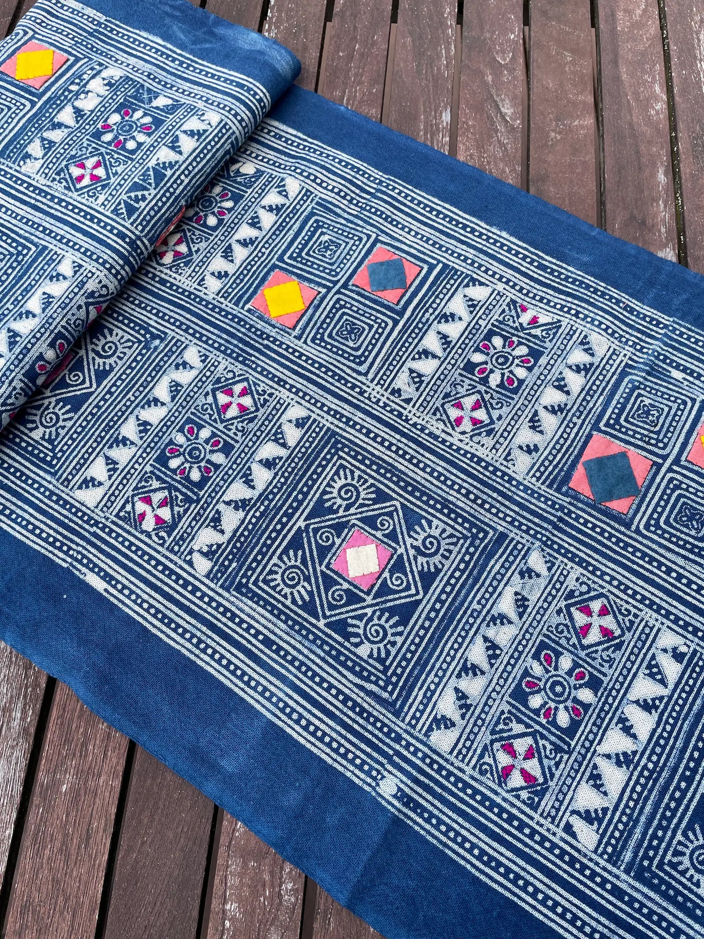Block print batik with embroidery and appliqué on cotton in geometric flowery pattern