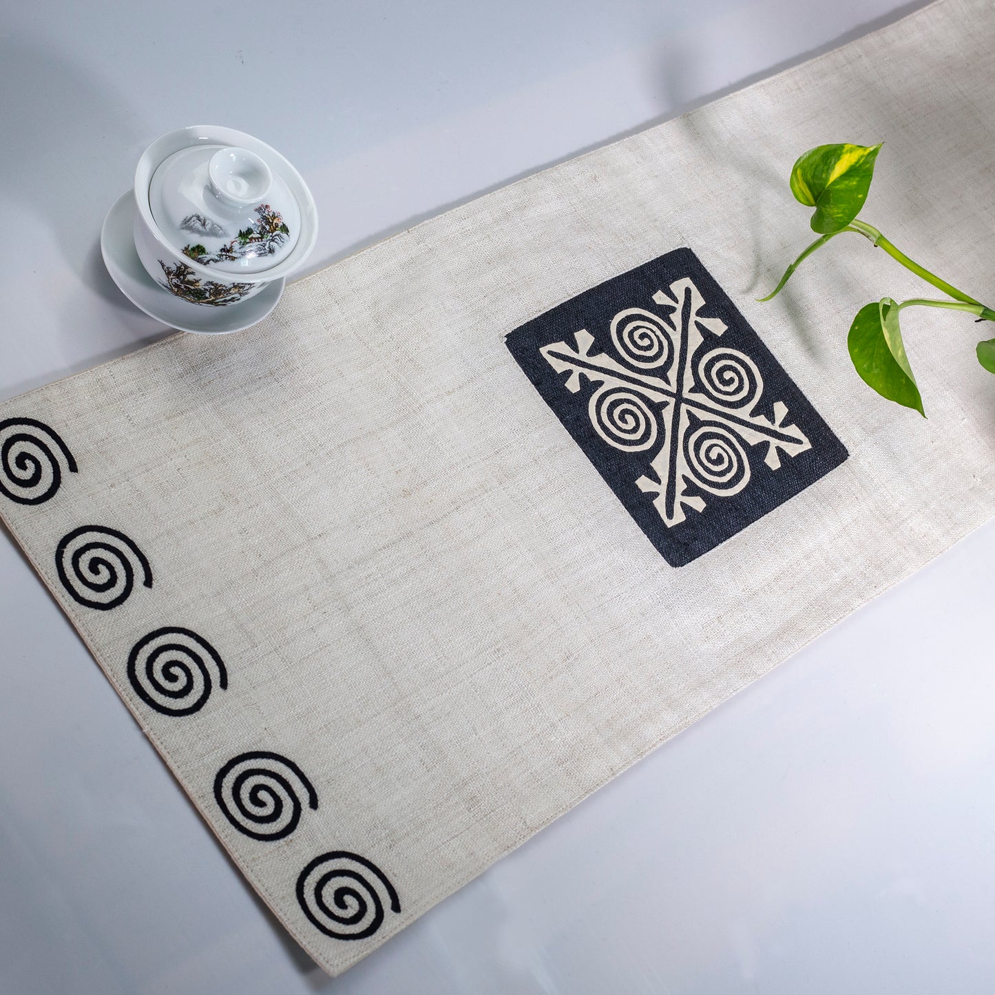 White Hemp Table Runner, patterns on black background, hand-stitched details at both ends