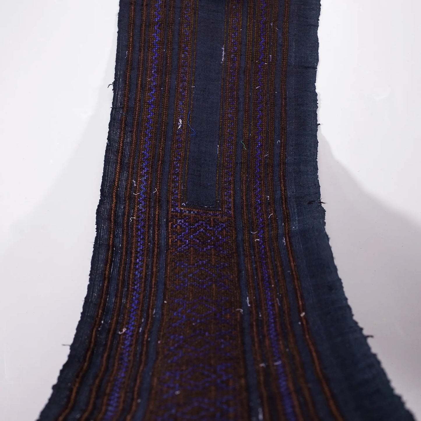 Vintage cross-stitch embroidery roll with shining brown and deep purple thread