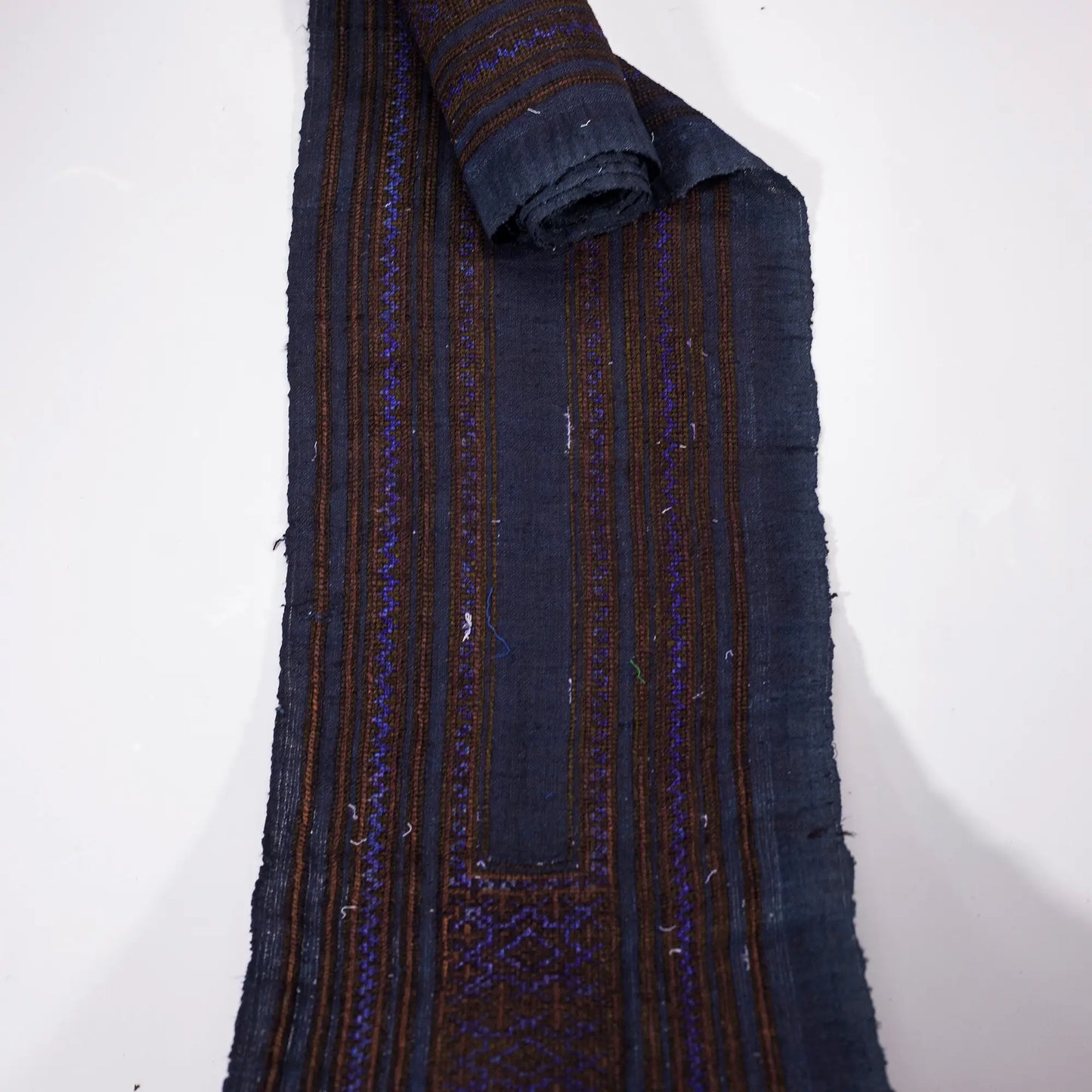 Vintage cross-stitch embroidery roll with shining brown and deep purple thread