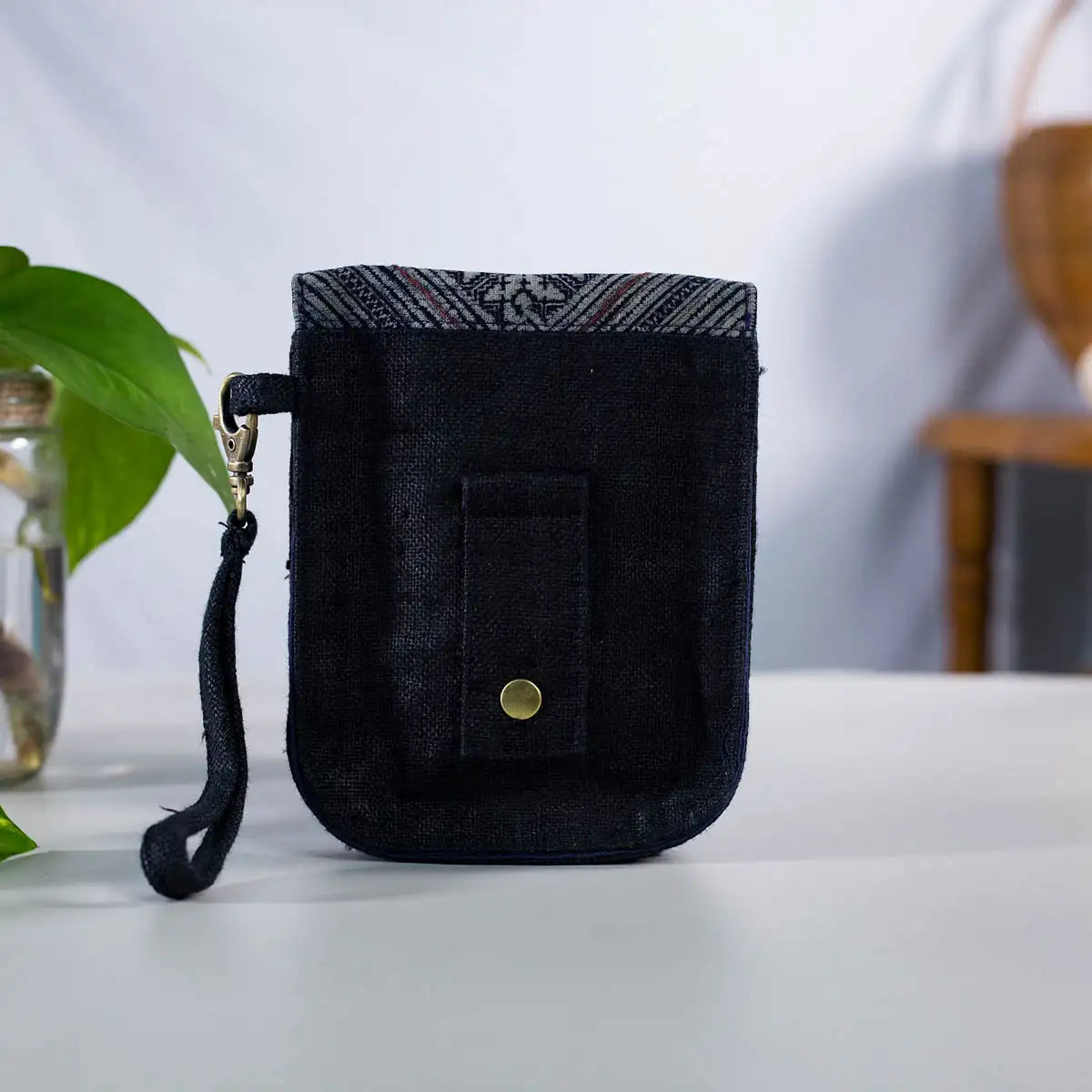 Back view of black hemp flip phone belt bag with adjustable strap, eco-friendly handmade design.