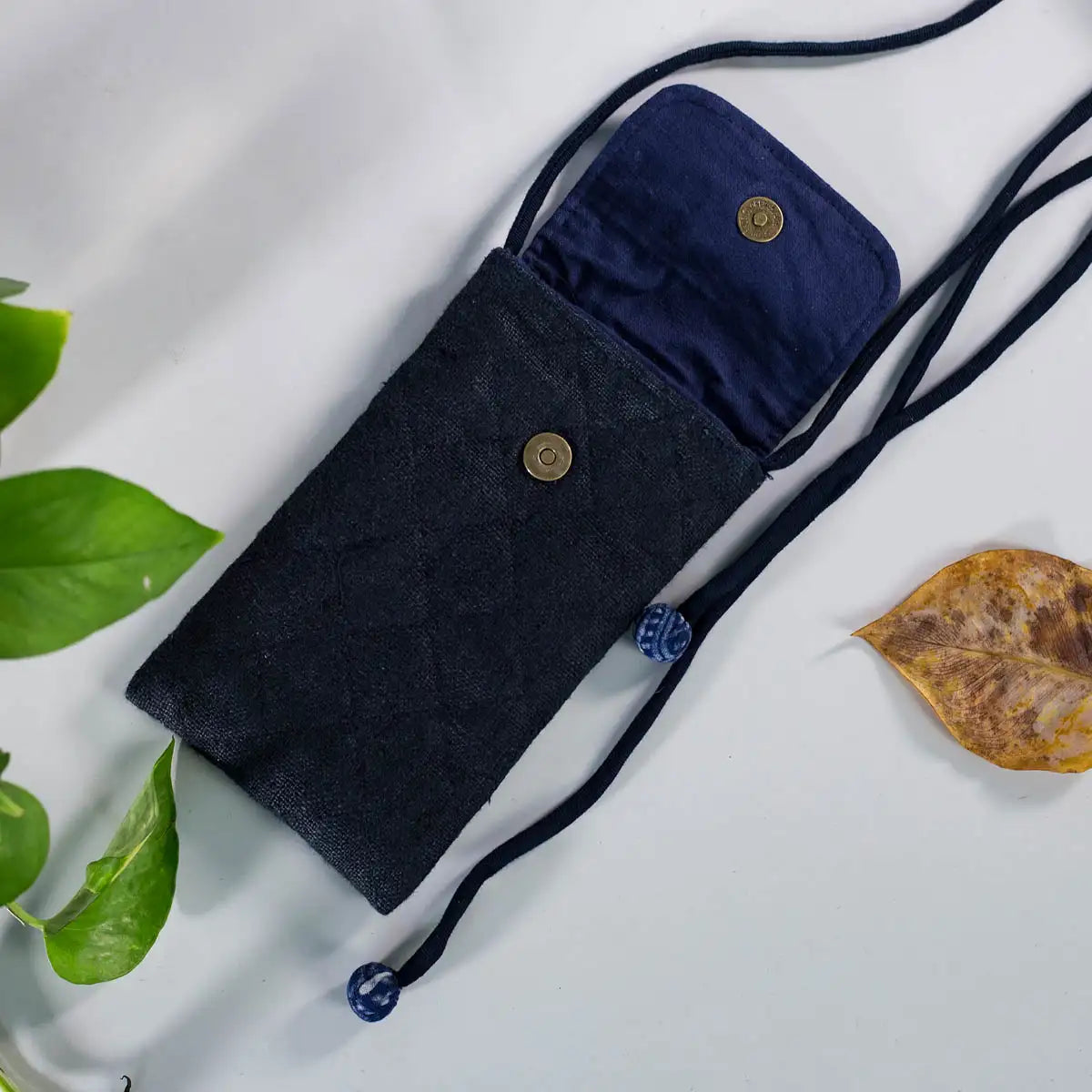 Interior view of black hemp phone bag with lining and magnetic button, sustainable handmade accessory.