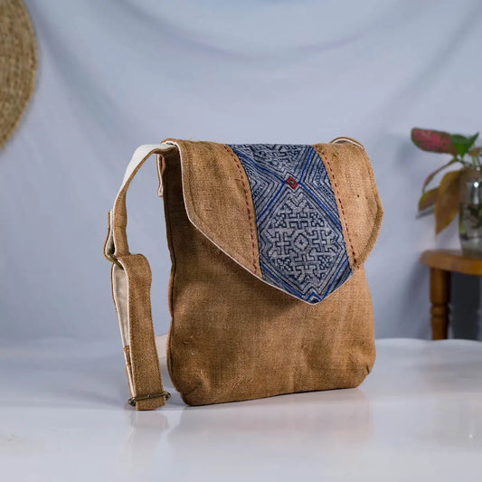 Angled view of brown hemp crossbody bag with vintage patch, sustainable handmade accessory.