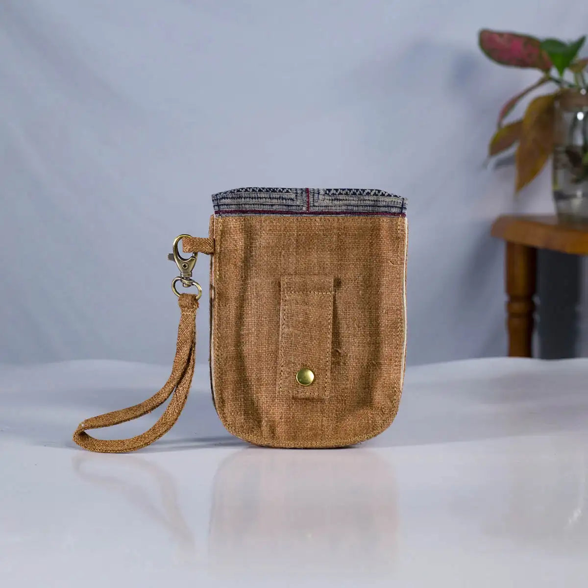 Back view of brown hemp flip phone belt bag with adjustable strap, eco-friendly handmade bag.