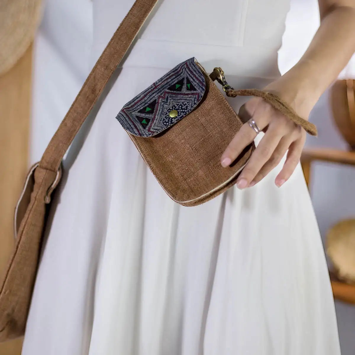 Model wearing brown hemp flip phone belt bag with vintage patch, eco-friendly handmade fashion