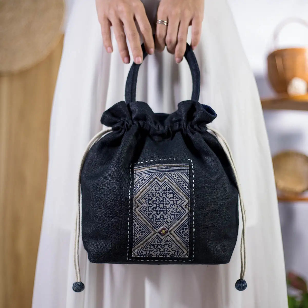 Front view of black hemp bucket bag with vintage H’Mong patch, eco-friendly Purity Collection bag