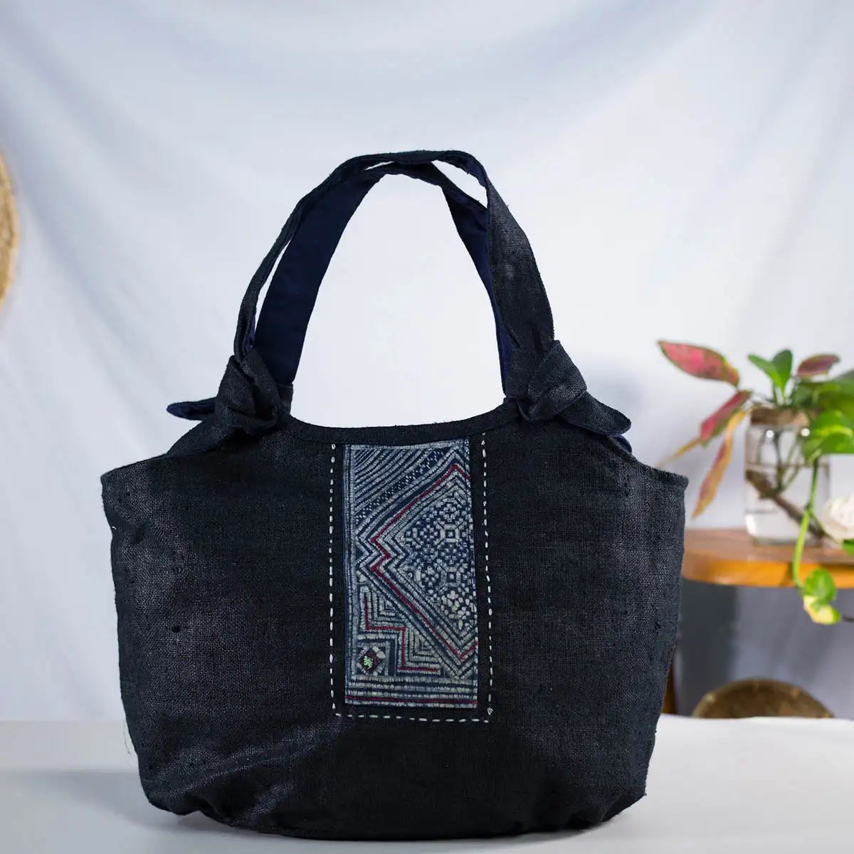 Front view of black hemp bunny ear handbag with vintage H’Mong patch, handmade design