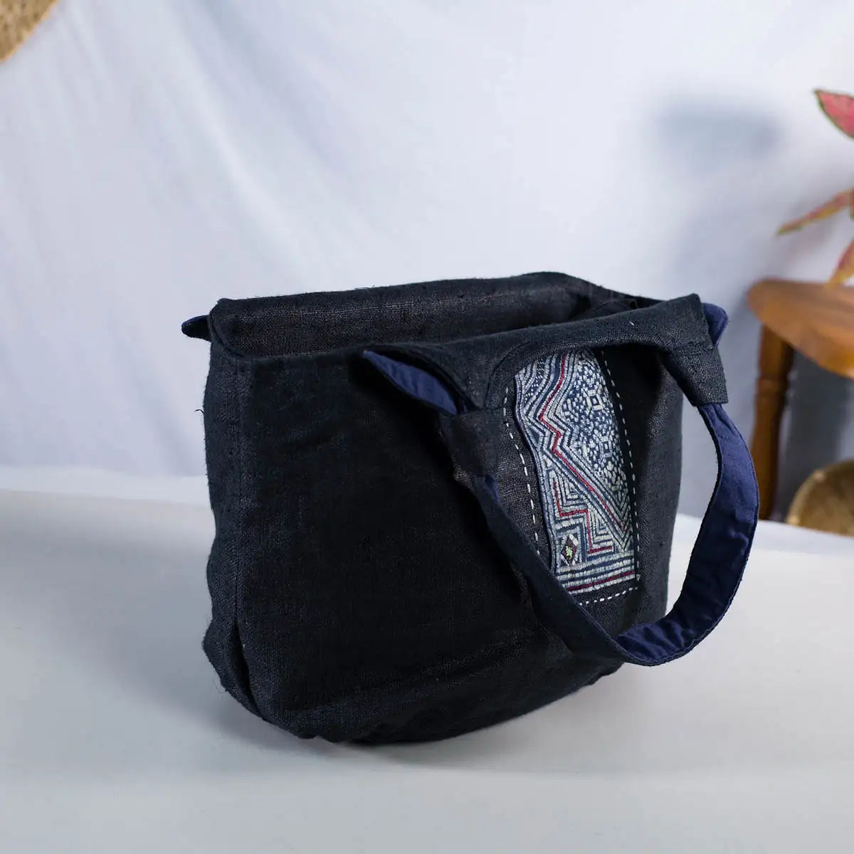 Inside view of black hemp bunny ear handbag showing cotton lining and vintage H’Mong patch