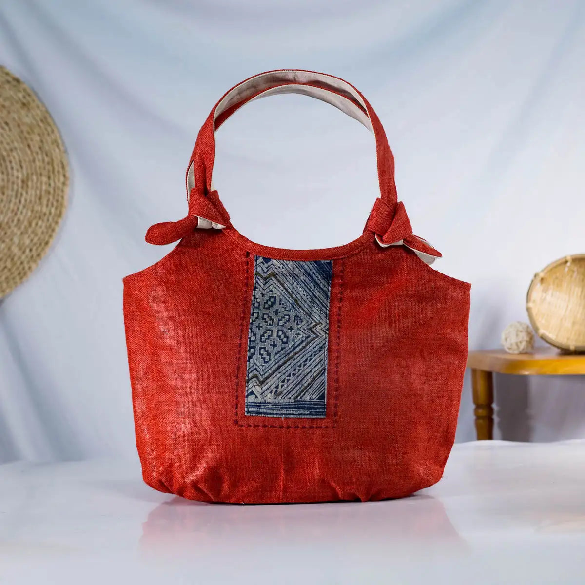 Front view of red natural hemp bunny ear handbag with vintage H’Mong patch from Purity Collection