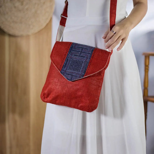 Front view of red natural hemp cross-body bag with vintage HMong patch, sustainable handmade fashion