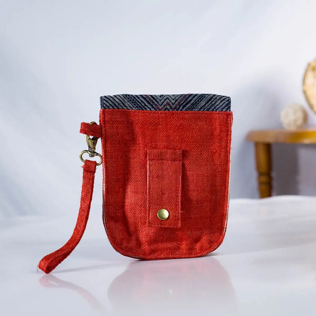 Back view of red hemp flip phone belt bag (mobilväska) with vintage H’Mong patch, handmade bag