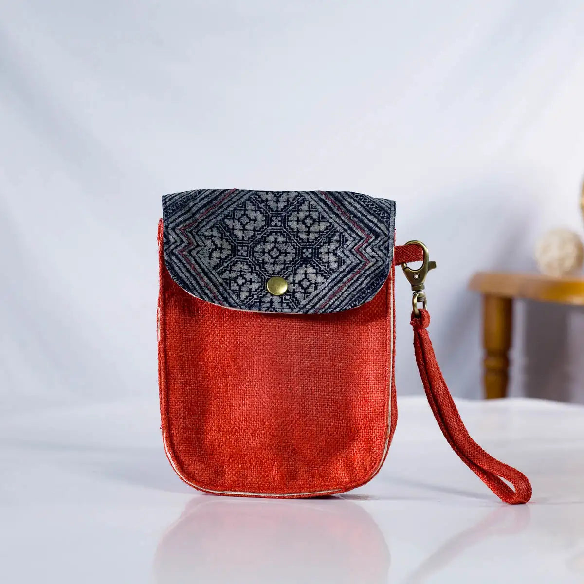 Front view of red hemp flip phone belt bag (mobilväska) with vintage H’Mong patch, eco-friendly bag