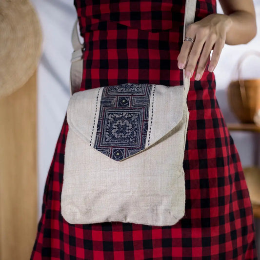 Model holding natural hemp handbag with bamboo handle and H’Mong batik patch, front view