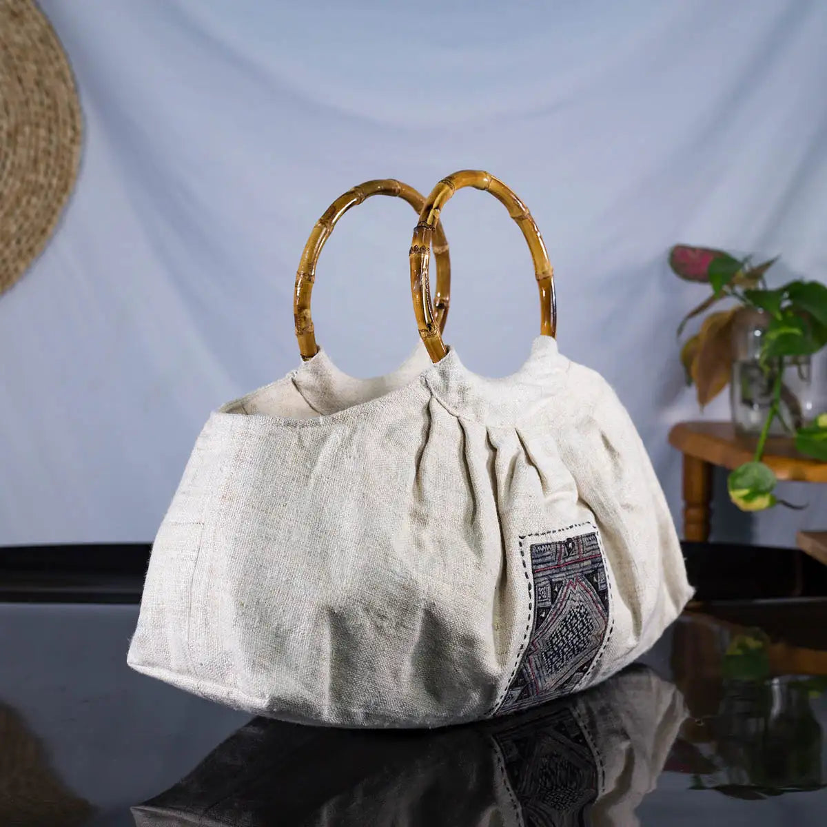 Natural hemp handbag with round bamboo handle and H’mong fabric patch