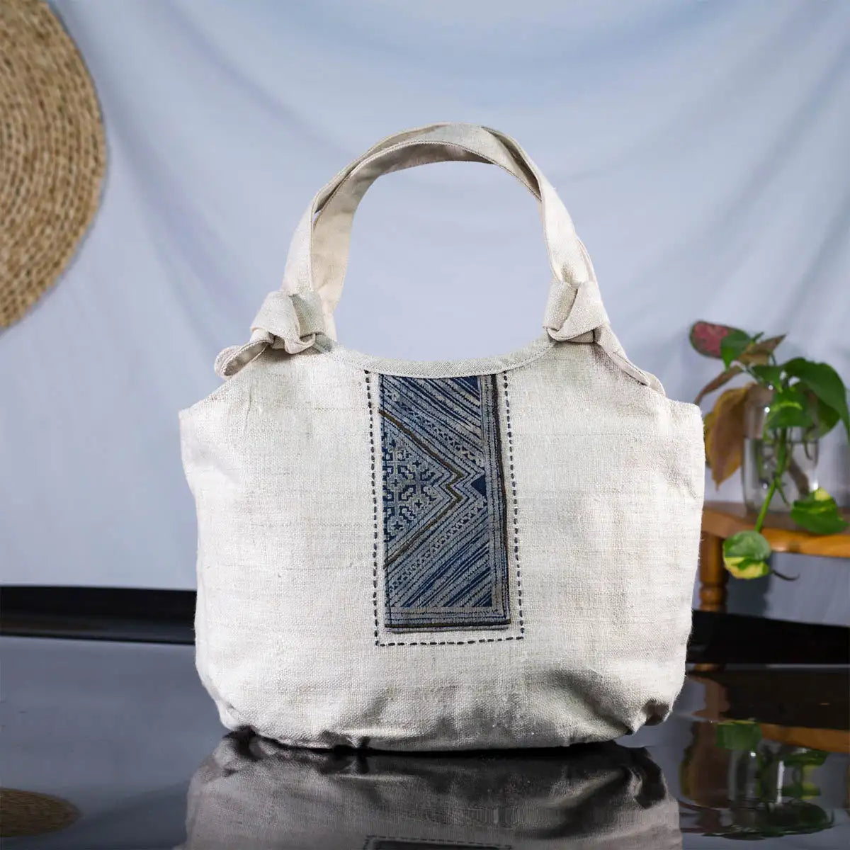 Eco-friendly hemp handbag with bamboo handle and grey batik patch, front view