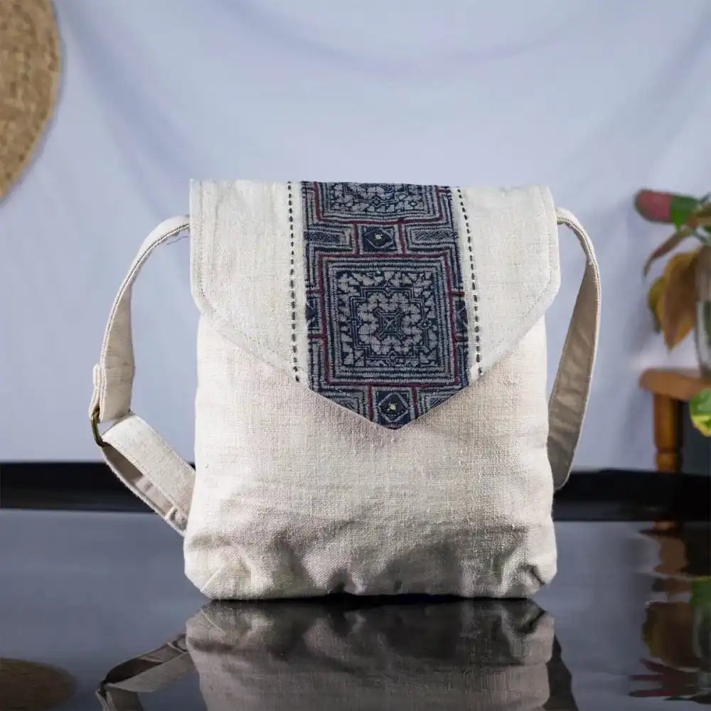 White hemp handbag with bamboo handle and grey batik patch, front display