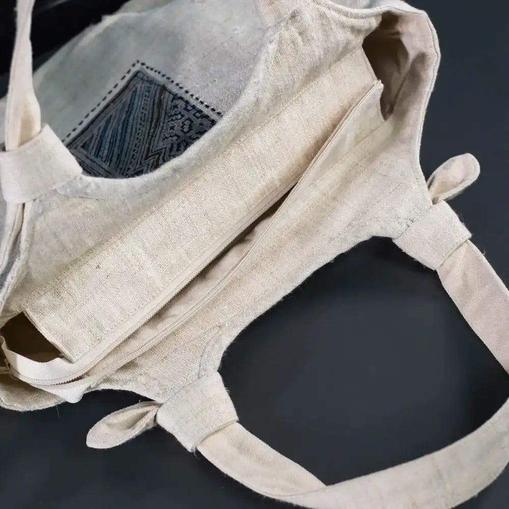 Open view of handmade hemp handbag with bamboo handle and spacious cotton lining