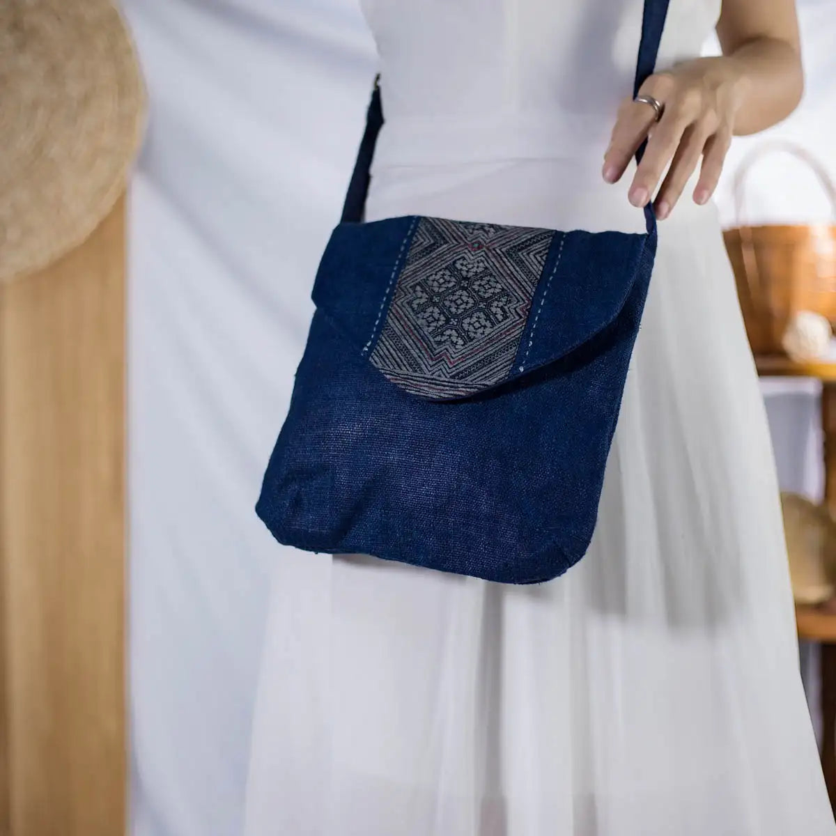 Indigo hemp crossbody bag with authentic H’mong patch, artisan-made sustainable fashion.