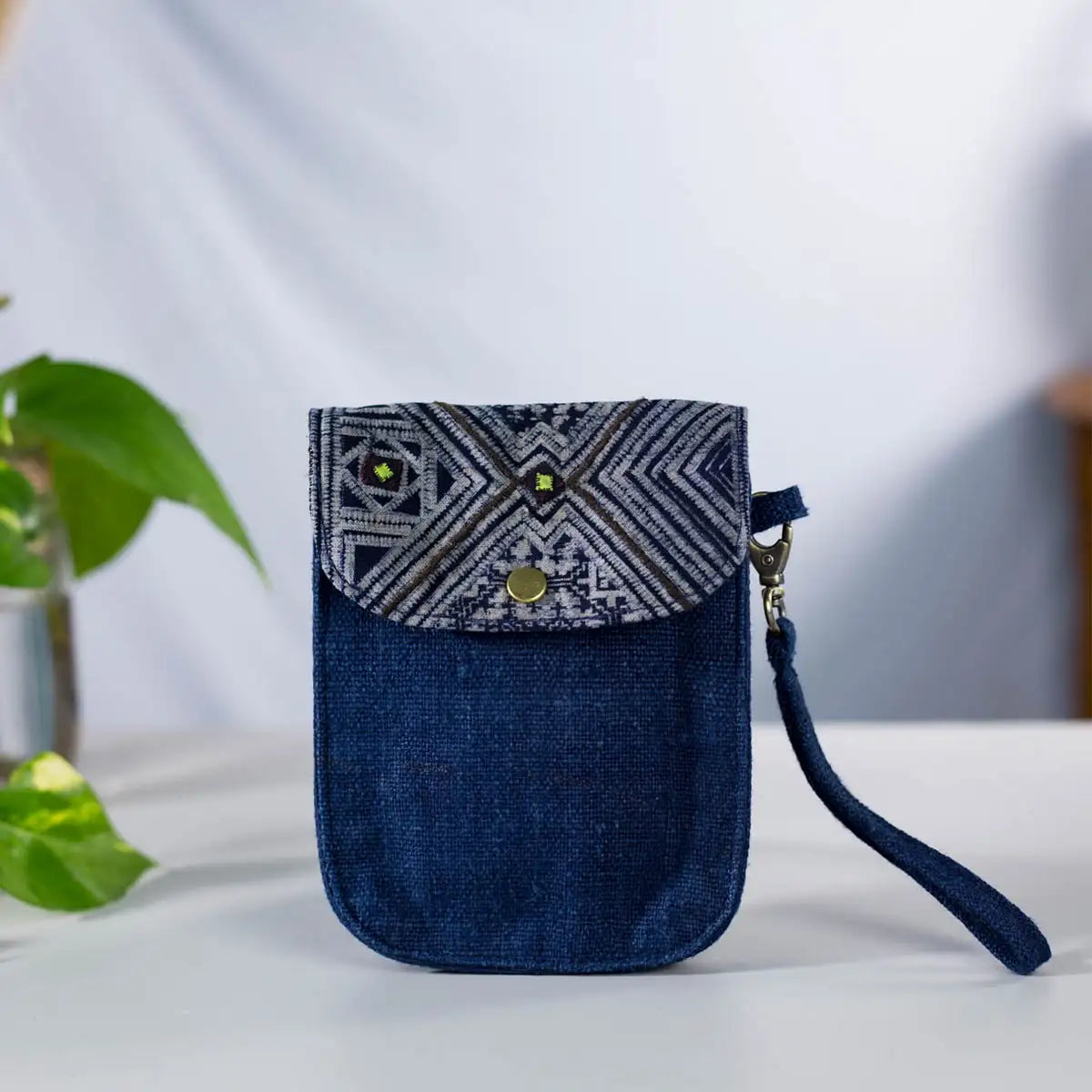 Indigo hemp phone bag with drawstring closure and H’mong patch, eco-friendly and handmade.