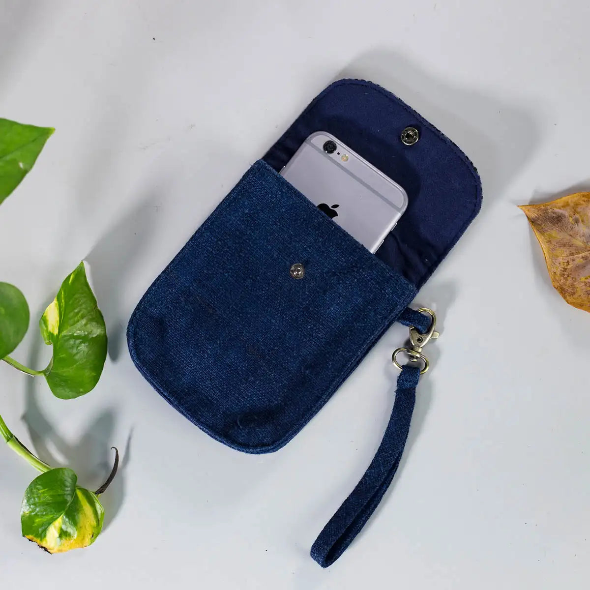 Open view of indigo hemp mobilväska phone bag with strap, showing H’mong patch detail.