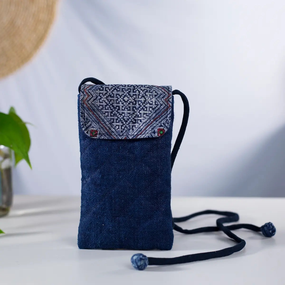 Front display of indigo hemp mobilväska, crossbody phone bag with authentic H’mong fabric patch.