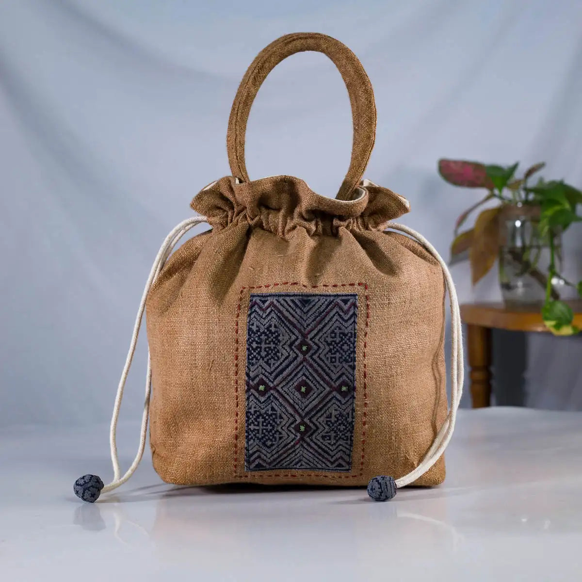 Front view of natural hemp bucket bag with H’Mong batik patch, eco-friendly handmade design.