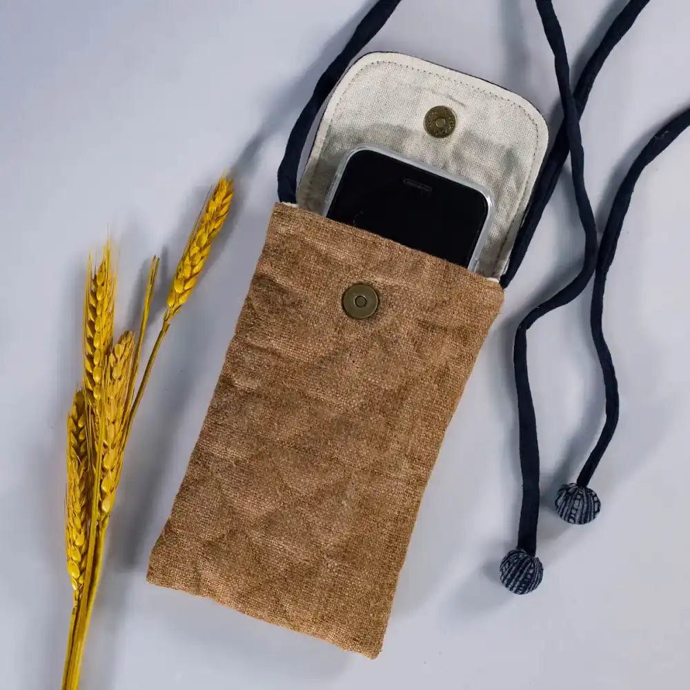 Open natural brown hemp phone bag with H’Mong patch, showing interior with phone inside.