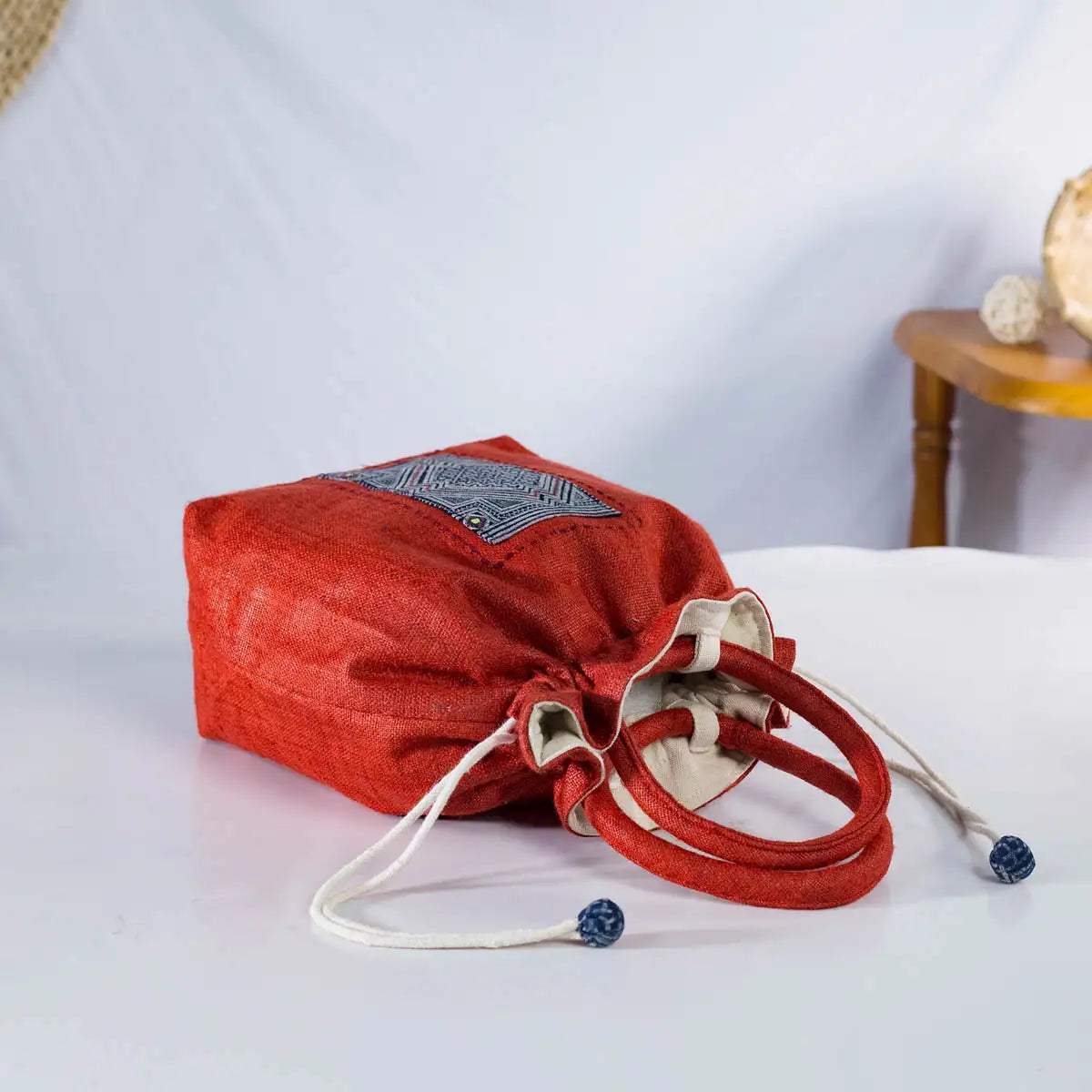 Top view of red hemp bucket bag with drawstring closure, sustainable and handmade craftsmanship.